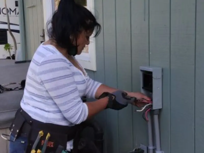 Licensed electrician wiring an exterior subpanel in Middleton